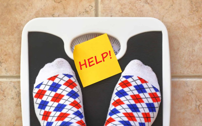 Woman's feet on bathroom scale. Diet concept